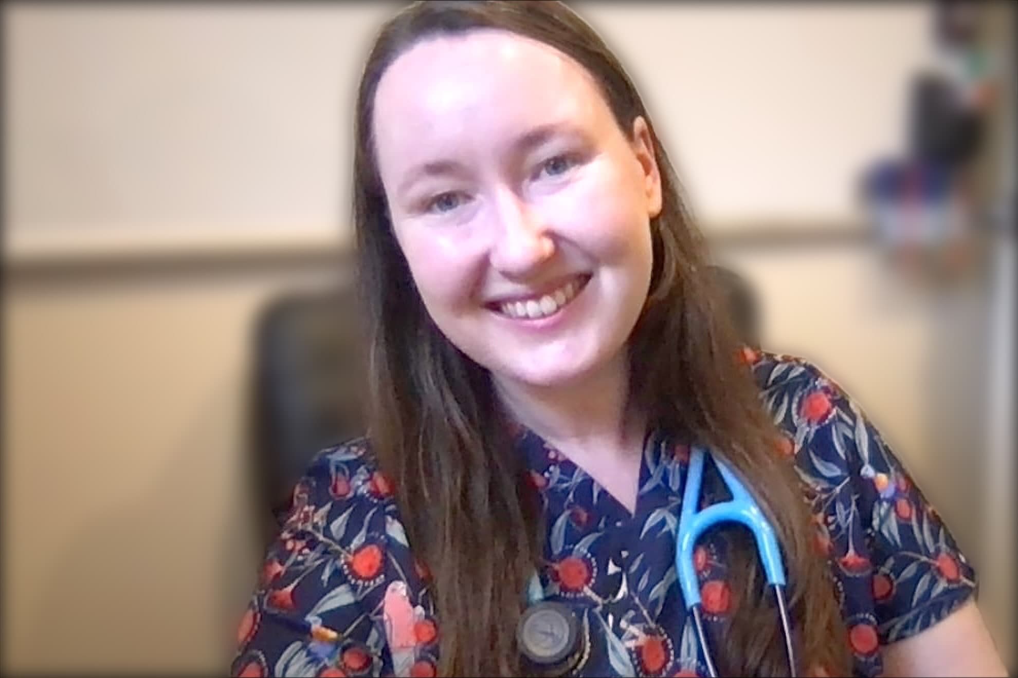 Dr Sarah Webb in scrubs with a stethoscope, on a video consultation